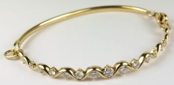 An 18ct gold and diamond mounted bracelet with graduated, brilliant-cut diamonds.