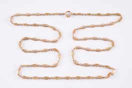 A late 19th century gold chain with oval links of open work design, the jump ring with French