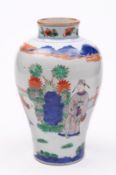 A Chinese porcelain vase of baluster form decorated in the Wucai palette with three figures in a