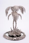 A 19th Century plated table centrepiece the stand mounted with a stag grazing under two palm
