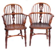 A Harlequin set of four early 19th Century yew-wood and elm stick back Windsor elbow chairs, the