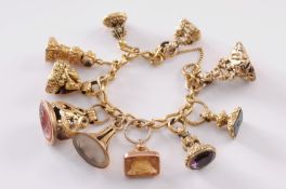 An 18ct gold curb-link bracelet with ten attached various fob seal charms, 151gm total all in