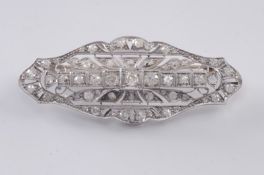 A platinum and diamond mounted oval brooch, of pierced design set with round old brilliant and