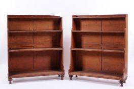 A pair of Regency mahogany and ebony strung ‘waterfall’ four tier open bookcases, each with a