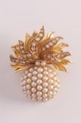 An early 20th century gold, split pearl and rose diamond ‘grenade’ brooch with split pearl-set