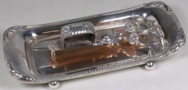 A plated candle snuffer of traditional design  together with a near matching tray of rectangular