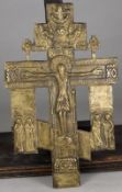 A late 19th/early 20th century Russian Orthodox cast brass crucifix decorated with the Holy Trinity,