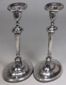 A pair of late Victorian silver candlesticks, maker Thomas Bradbury & Sons, London 1897 with