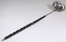 A 19th Century silver punch ladle, oval bowl and turned whale bone handle, 32cm long.