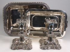 A pair of plated candlesticks and entree dish with cover.