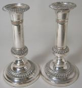 A pair of epns candlesticks of plain form with gadrooned  knopped stems on domed circular base,