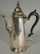 A silver coffee pot, in the George III style, with shaped stained ebony handle, maker Thomas