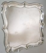 An Edward VII  square silver salver, maker JD&S, Sheffield, 1902 with plain moulded border,on scroll