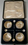 A set of four Edward VII salts, Birmingham, 1908 of shell shaped outline raised on ball feet, with