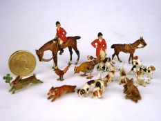 A cold painted bronze miniature hunting group:, with huntsman and hunts woman on horse back,