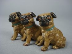 An Austrian Geschulz cold painted bronze of a trio of seated pug dogs:, 7.3cm long.