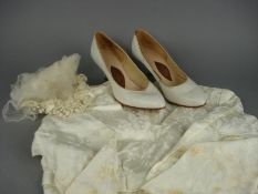 A mid 20th Century cream silk floral embroidered one piece wedding dress, wedding veil and cream