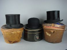 Two black felt top hats in leather cases and a black felt bowler hat:.