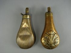 Two Victorian copper powder flasks with repousse shell decoration: (2)