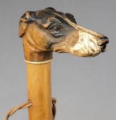 An early 20th Century carved dogs head handled parasol:, the dogs head inset glass eyes and