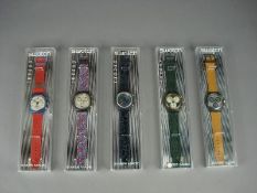 Five various Swatch watches in original cases: Silver Star Chrono, JFK SCN10, SIR10, Rollerball