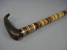 A 19th Century horn sectional walking cane:, the one piece handle above brass ferrule and tapering