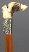 A Victorian white metal mounted and antler carved dogs head handled riding crop:, the dogs head
