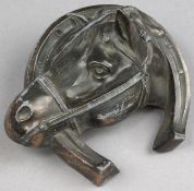 A late Victorian spelter horse head ink well:, in a horseshoe mount.