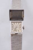 A lady’s ‘Para’ wristwatch the square dial with baton markers concealed beneath a white precious