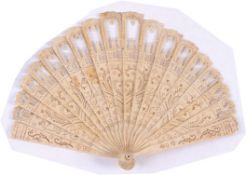 An early 19th century brise fan of graduated form, the bone sticks having pierced fret work