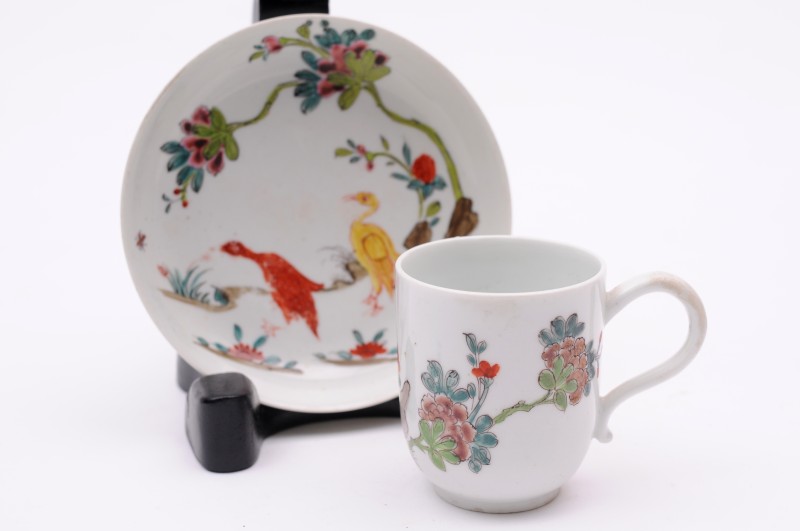 A Longton Hall matched coffee cup and saucer the cup with large scroll handle, painted with the ‘