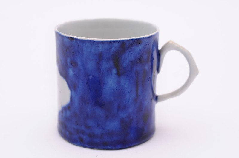 A West Pans coffee can with scroll handle, decorated in deep cobalt blue around a shaped white