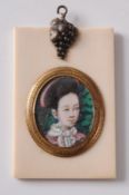 A Chinese oval miniature of a young girl in traditional costume contained in an ivory frame, 7.