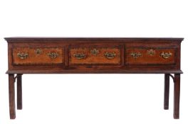 A George III oak low dresser, with three crossbanded frieze drawers and on square legs, 183cm (6ft