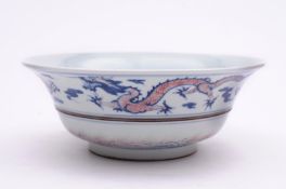 A Chinese porcelain shallow bowl of mildly everted form with central incised band decorated in