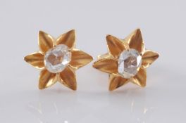 A pair of rose diamond mounted single-stone ear-studs of six-pointed star design.