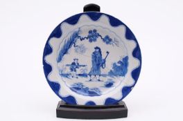 A Bow blue and white small deep plate painted with the ‘Golfer and Caddy’ pattern within a wavy blue