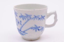 A Bow blue and white coffee cup with angular handle, painted with oriental trees and flowering