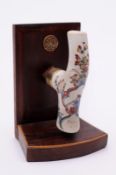 A Saint Cloud cane handle of shaped T form, painted in enamel colours with floral sprays and a man