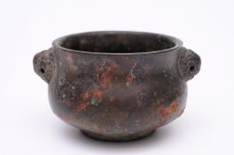 A Chinese bronze censer of small size with mask head handles (rings missing), bears six character