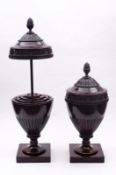 A pair of carved mahogany cutlery urns in the Adam taste the rising covers with fluted, paterae