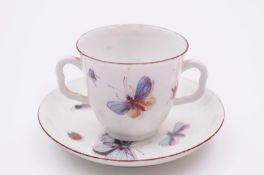 A Chelsea two handled cup and matched saucer painted in enamels with ‘shaded’ butterflies and