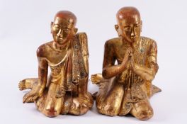 A pair of carved hardwood and gilt decorated figures of Moggalanna and Salibutta, with inset foil