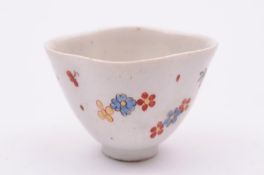 A Bow teabowl of quadrilobed form , painted with scattered flowers outlined in black in the Kakiemon