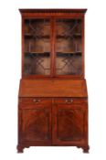 A George III mahogany bureau bookcase, the upper part with a moulded dentil cornice and arcaded