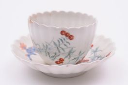 A Chelsea matched teabowl and saucer of foliate fluted form, decorated in the Kakiemon manner with
