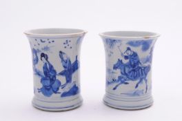 A matched pair of Chinese blue and white brushpots of waisted cylindrical form with flared rims, one