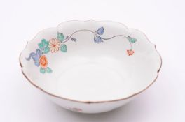 A Chantilly bowl of flowerhead form with shaped brown line rim, painted in the Kakiemon palette with