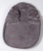 A Chinese stone brush washer or inkstone carved in relief with a dragon amongst cloud scrolls, 21