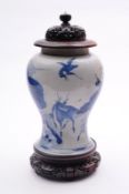 A Chinese porcelain baluster vase boldly painted in blue with two deer and two cranes in a rocky and